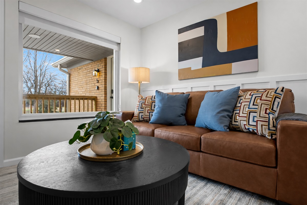 Unwind in this stylish living room with plush seating, modern décor, and abundant natural light—an inviting spot to relax after a full day.