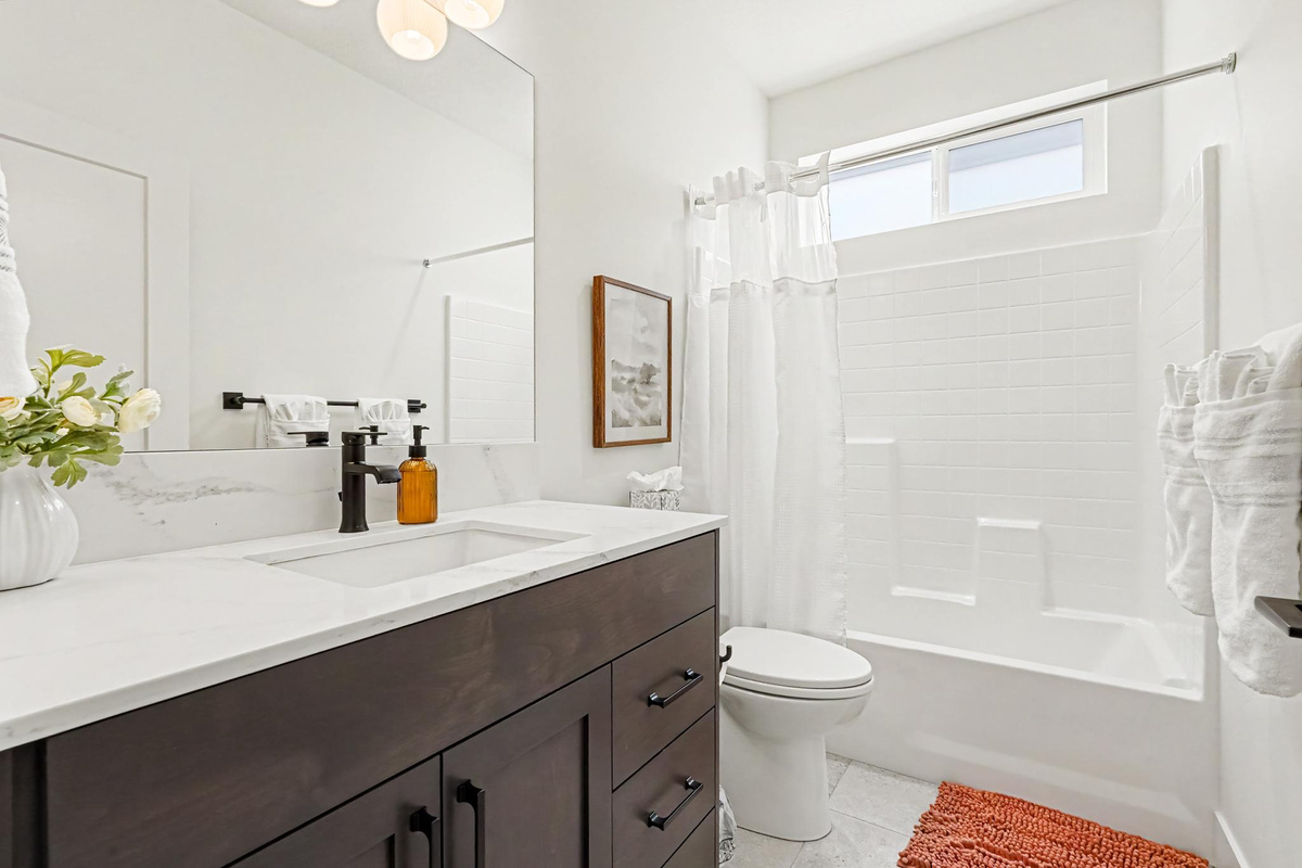 Enjoy the bright and spotless main bathroom, designed with comfort and convenience in mind.