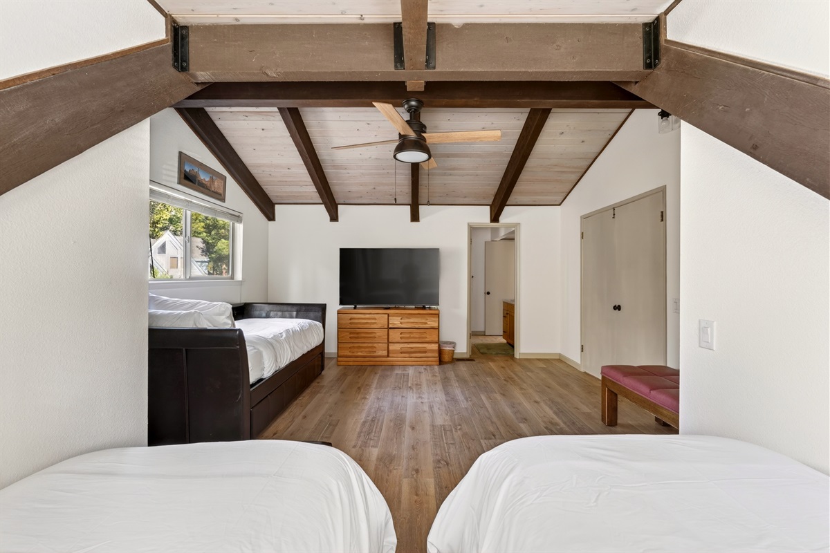 Bedroom 4 is a fun and spacious retreat, featuring three twin beds and a large Smart TV—perfect for kids to relax, unwind, and enjoy their own space.
