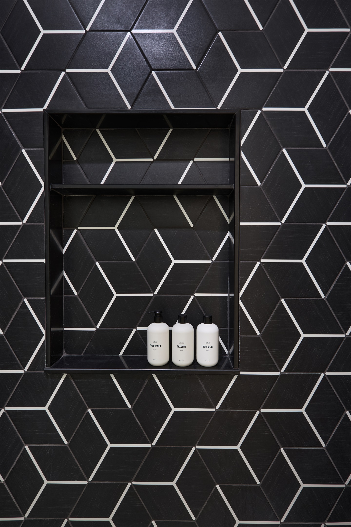 Modern elegance in every detail—geometric tile and luxury toiletries in the upstairs bath.
