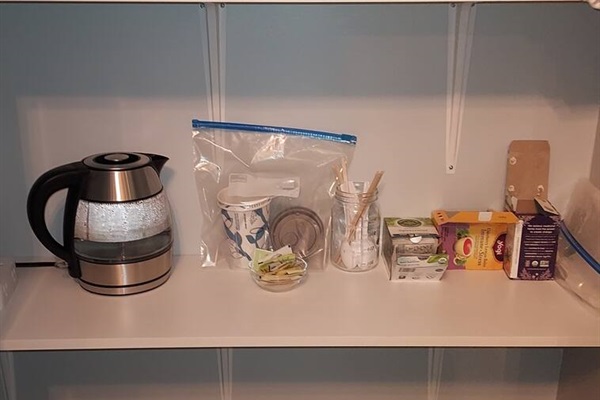 A cozy wellness tea station awaits on the closet shelf in the spa bathroom—perfectly placed for sipping something soothing while you unwind in the jetted tub. Thoughtfully tucked away, it offers easy access without intruding on your space to relax.