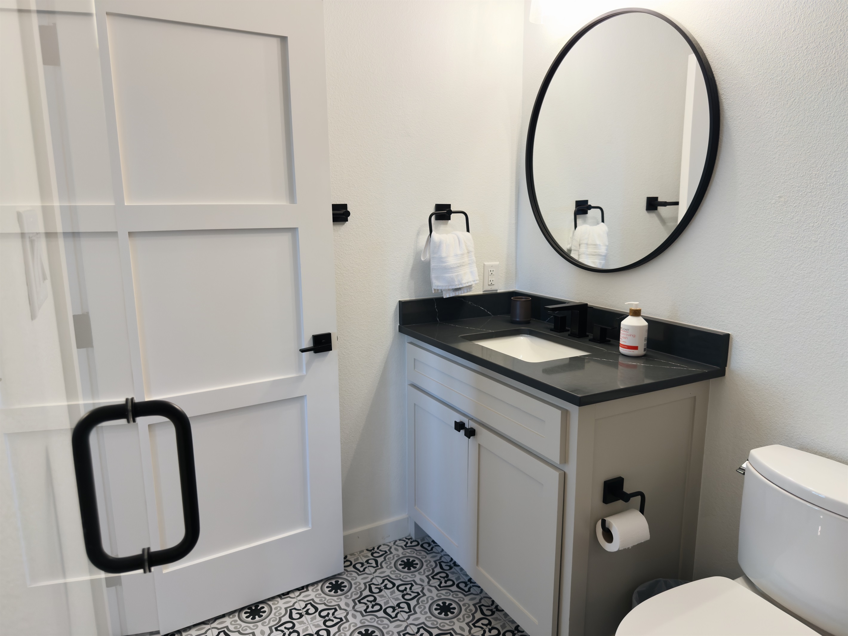 Clean, modern bathroom with updated fixtures, fresh towels, and thoughtful details.