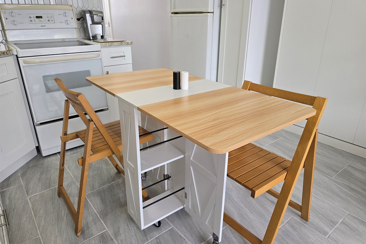 Compact fold-out dining table