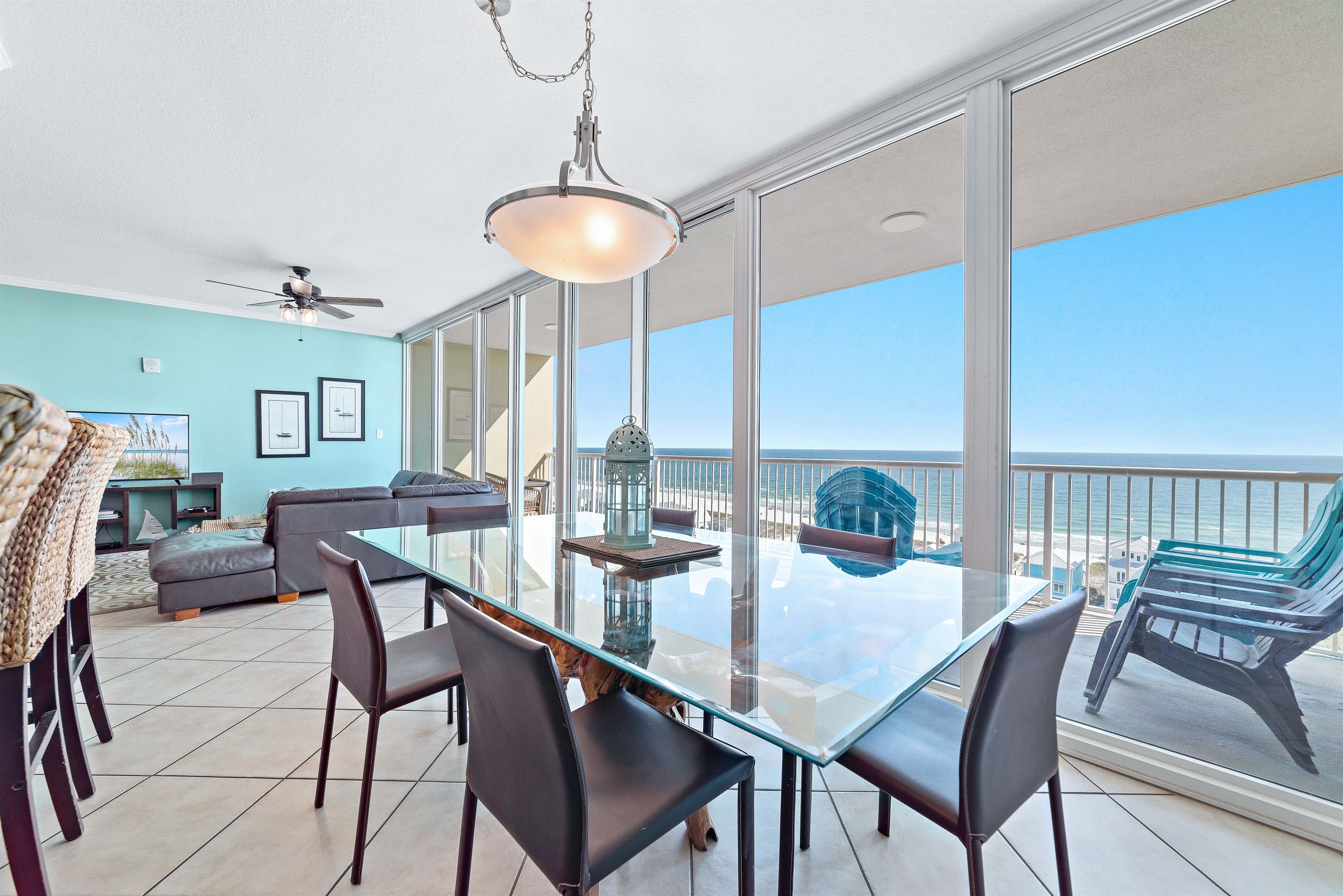 Indoor-outdoor living seamlessly blends in this dining space, with direct access to a balcony overlooking the stunning ocean.
