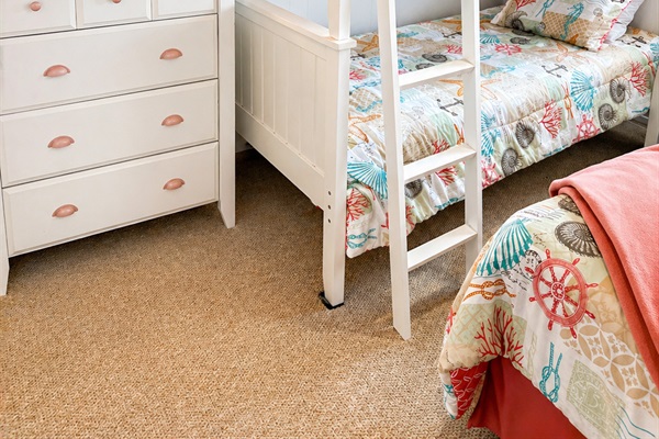 A single twin bed and twin bunk beds, along with a closet and a chest of drawers. (Lower floor)