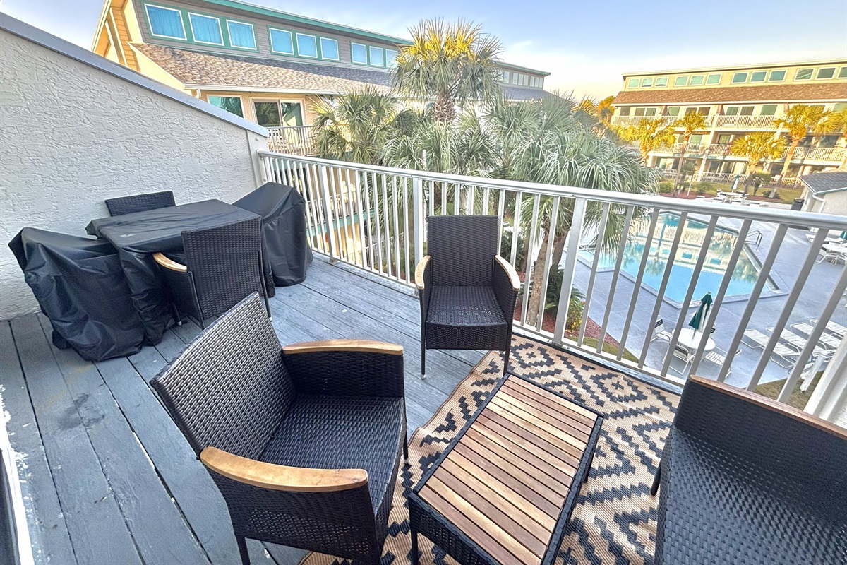 Spacious balcony overlooking pool area