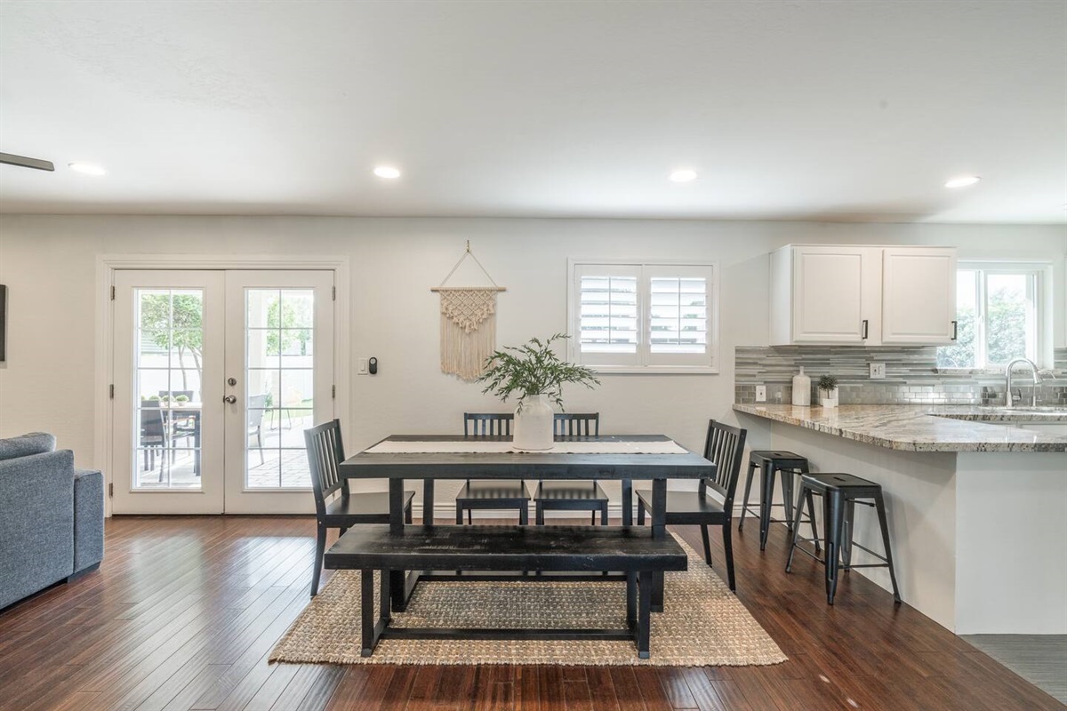 Large dining table and breakfast bar provide plenty of seating for meals.