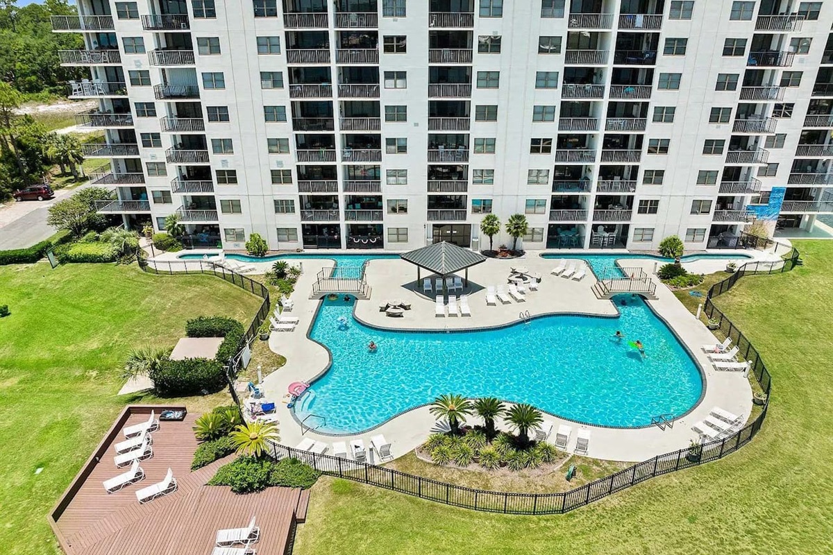 Poolside Paradise: Relax in style at our sparkling pool surrounded by lush greenery!