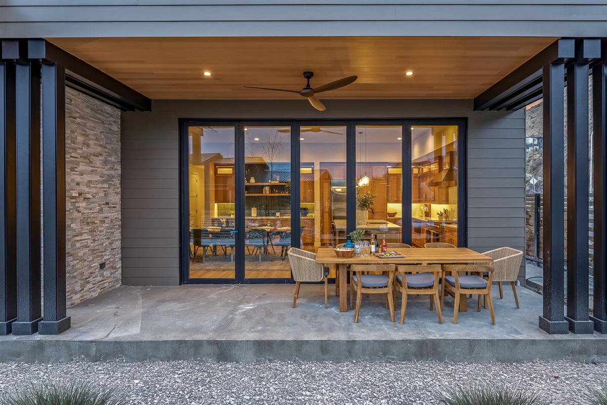 Outdoor dining with lake views and Traeger pellet grill available for guests