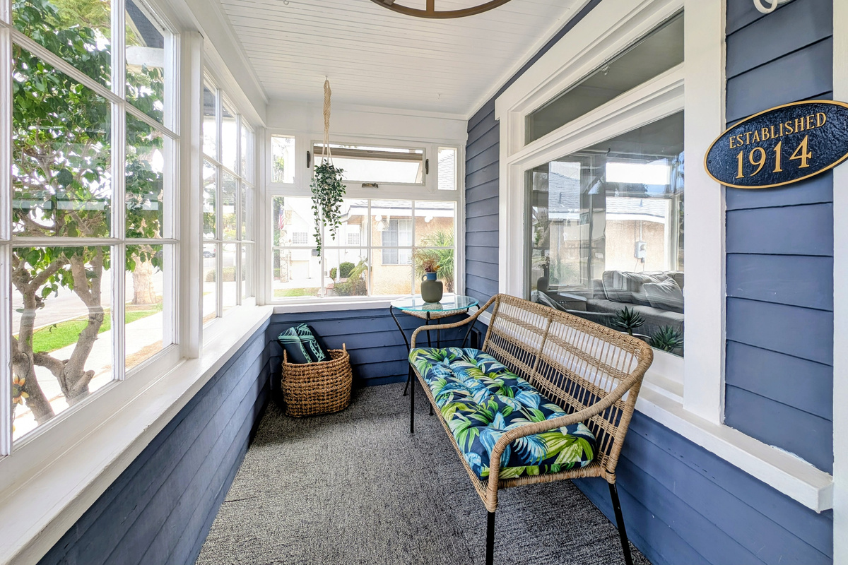 Cozy and bright sunroom with comfortable seating.