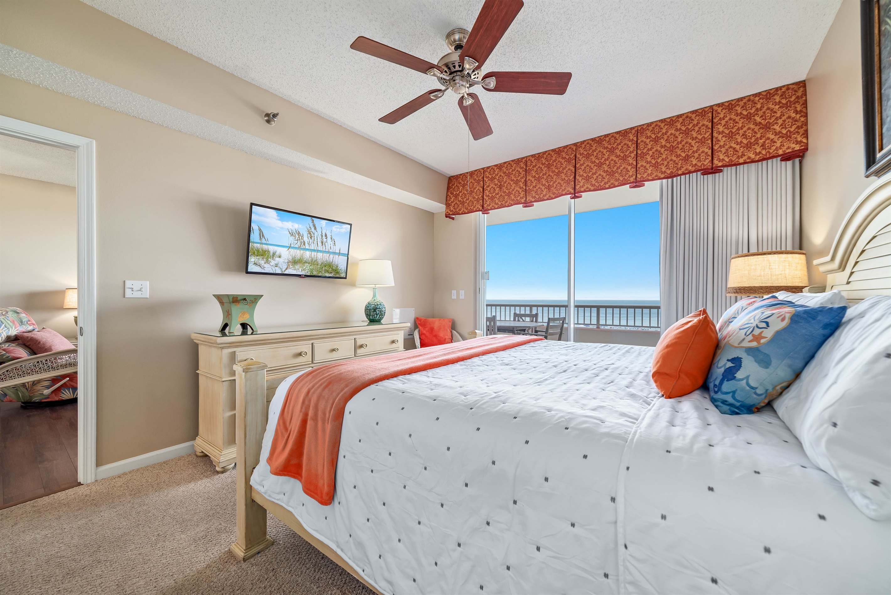 Enjoy the perfect blend of comfort and coastal beauty in this inviting bedroom with direct balcony access and stunning ocean views.