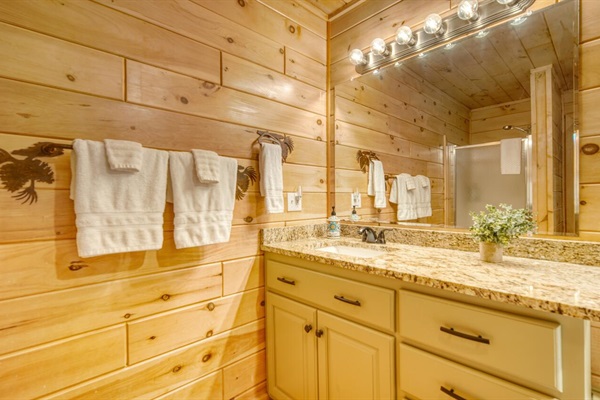 Primary bathroom with granite countertops, jacuzzi tub and shower