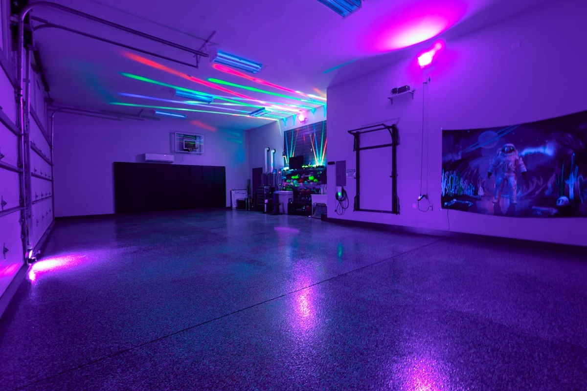 Garage with blacklights and lasers on.