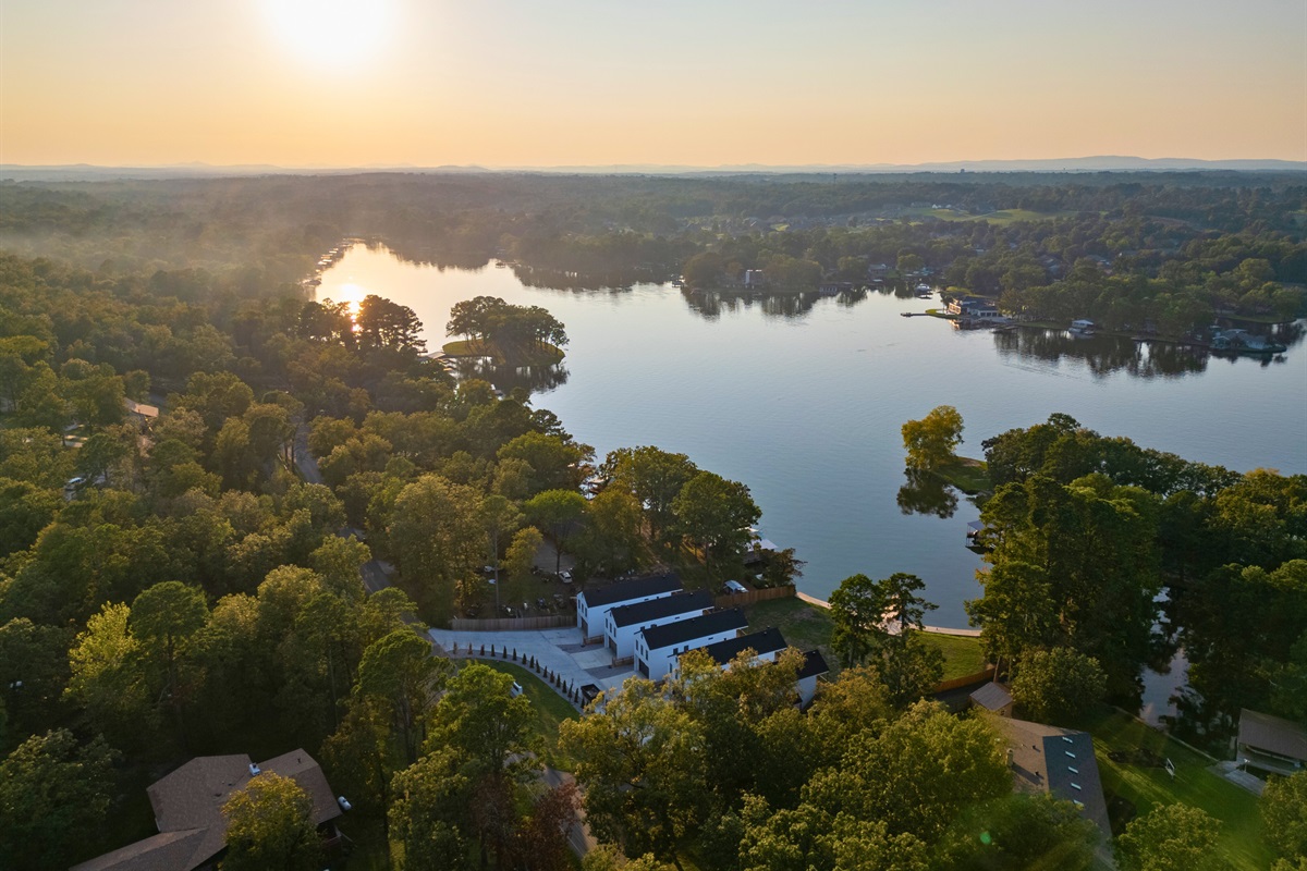 Looking out over the lake, the water stretches calmly through the surrounding trees.