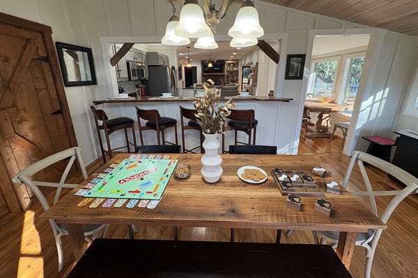 Gather around the spacious farmhouse table for games, snacks, and cozy connection just steps from the kitchen and sunlit dining nook.