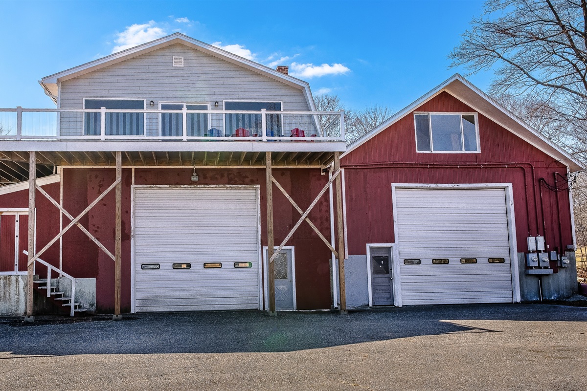 The Aerie: A high-elevation maritime loft perched above its historic "Quiet Side" roots. This front-on view showcases the impressive height of our 75-foot wrap-around deck, offering your group a private, bird's-eye perspective of Southwest Harbor.