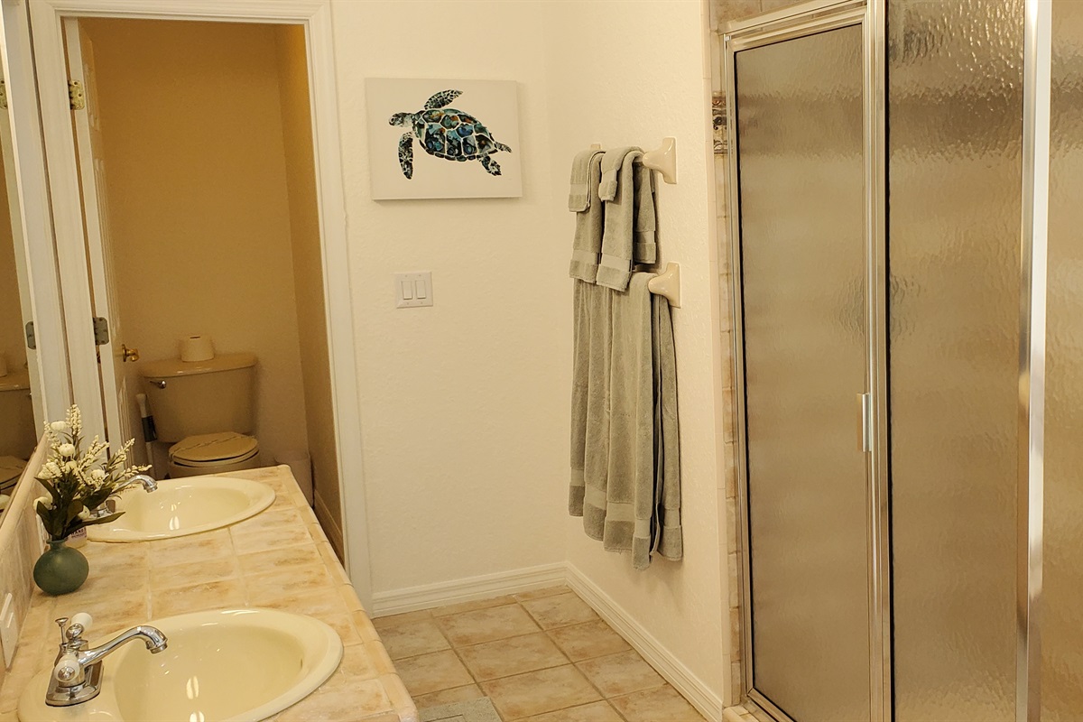 Master Queen bathroom with double sinks, walk-in shower and sunk-in tub.