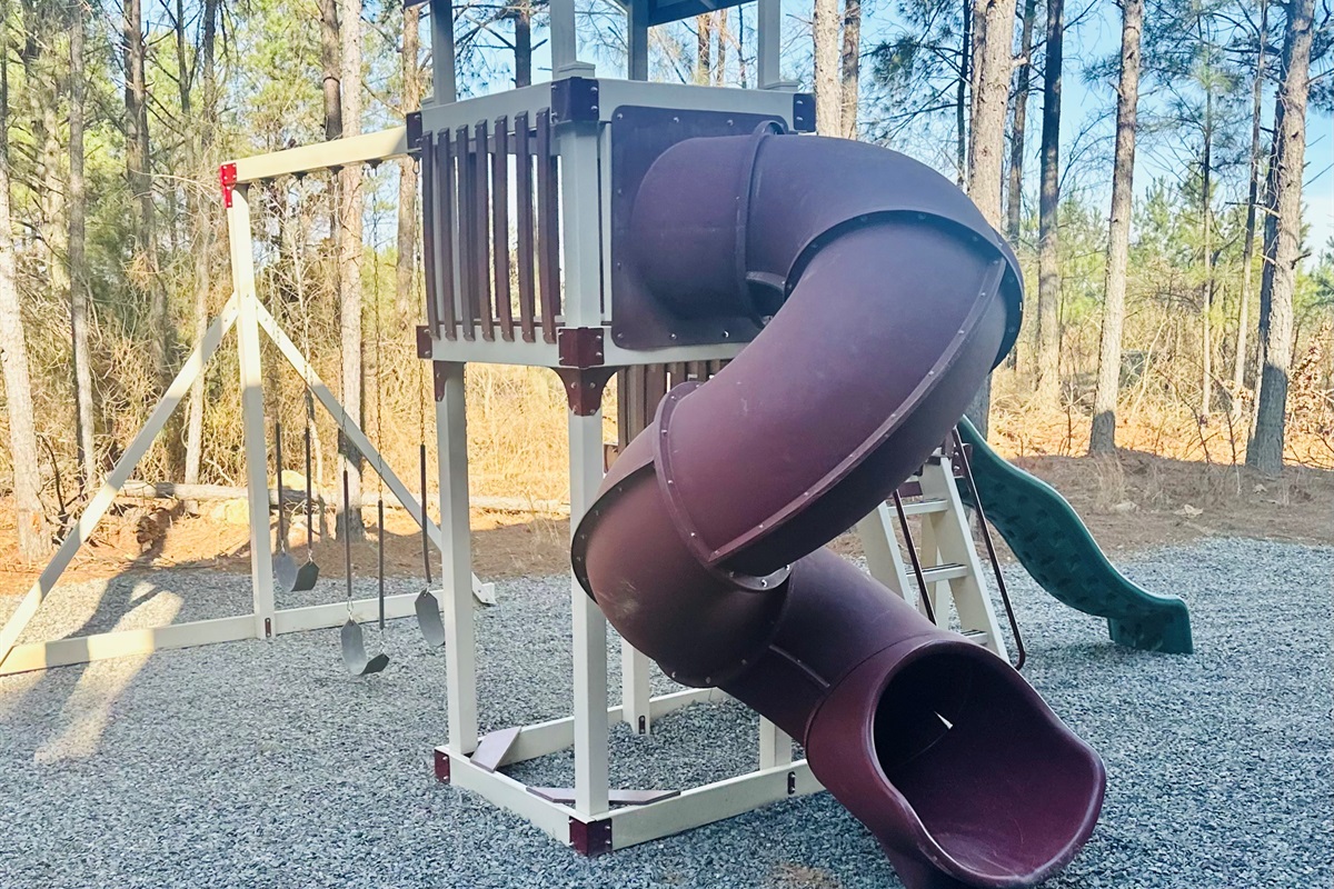 Outdoor playground set with swings and slides for kids to enjoy.