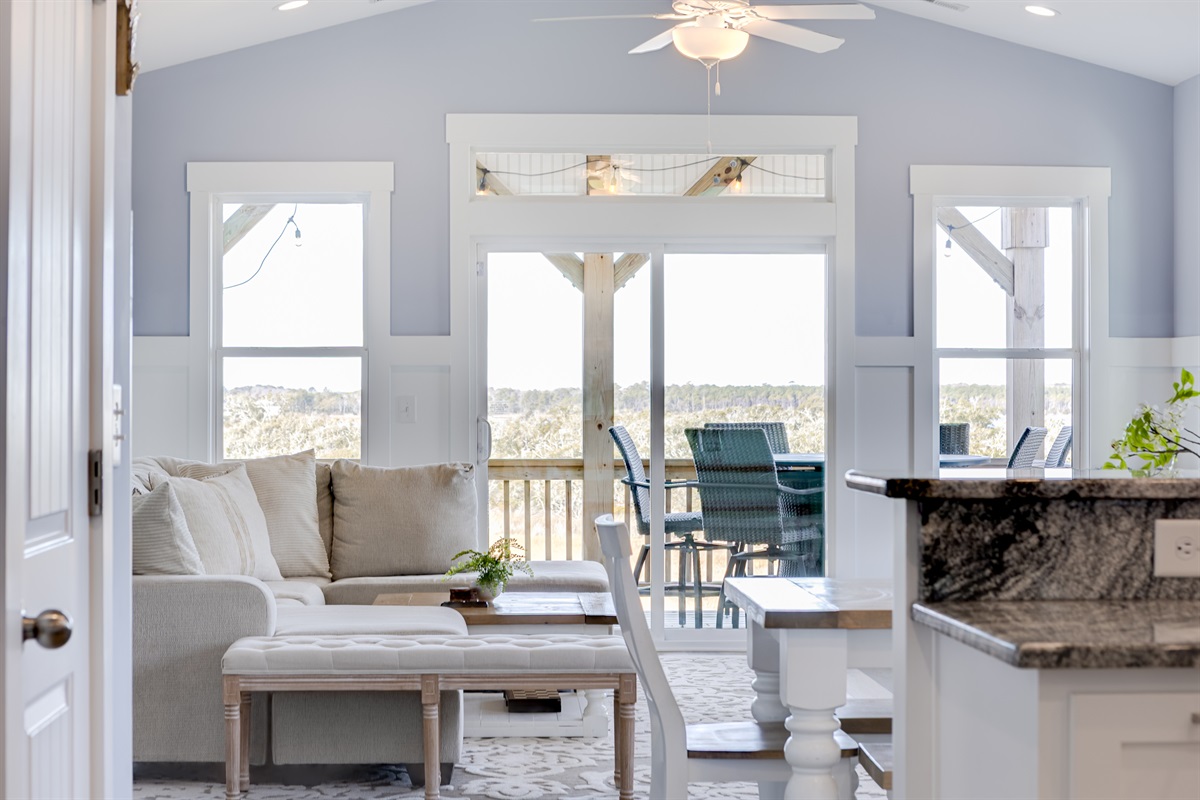 Open living and dining area with seamless flow to the covered balcony and Sound views beyond