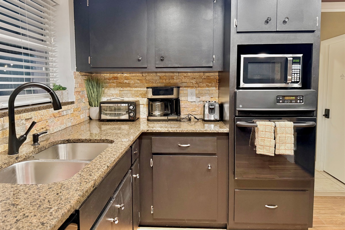 With ample granite countertop space, dual sinks, and a clean, organized layout, this kitchen is ideal whether you're preparing family dinners or late-night bites.
