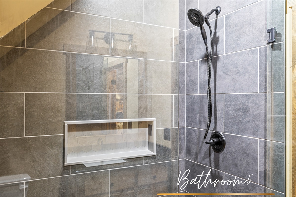 Bathroom 5: A glass-enclosed walk-in shower offers both style and functionality in this beautifully designed bathroom.
