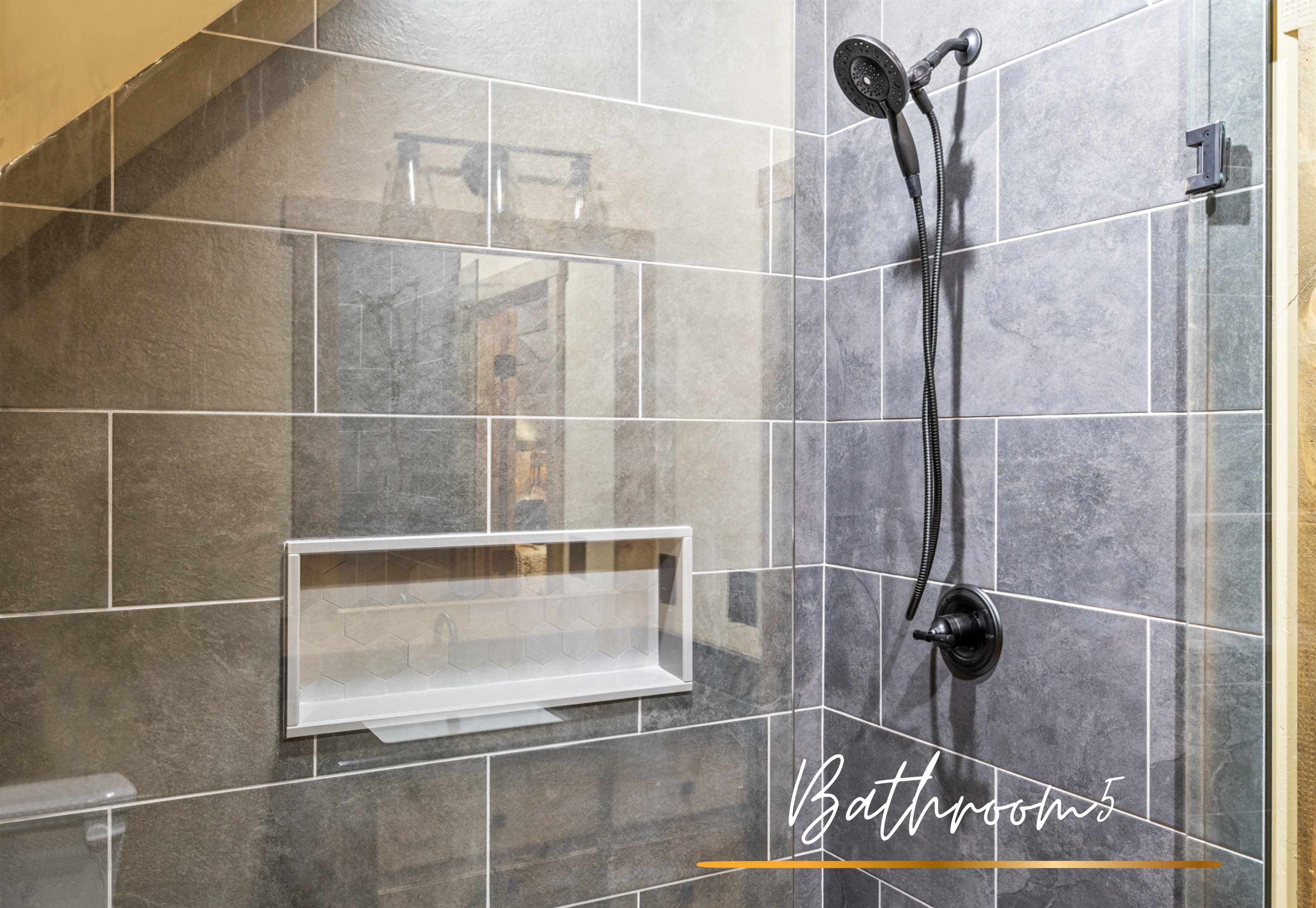 Bathroom 5: A glass-enclosed walk-in shower offers both style and functionality in this beautifully designed bathroom.