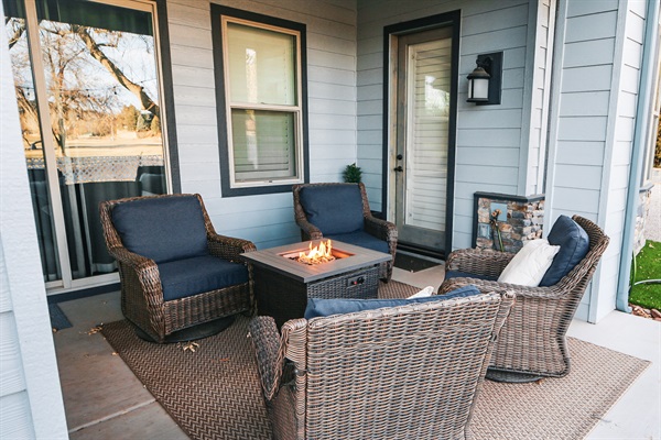 cozy firepit with swivel rockers on the back patio