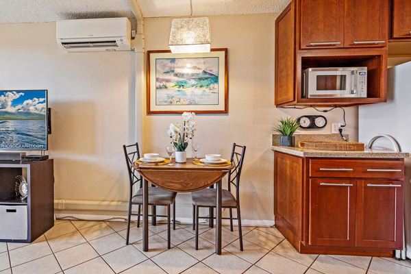 Seating for two at table. Leaves expand & chairs from outside can be used inside