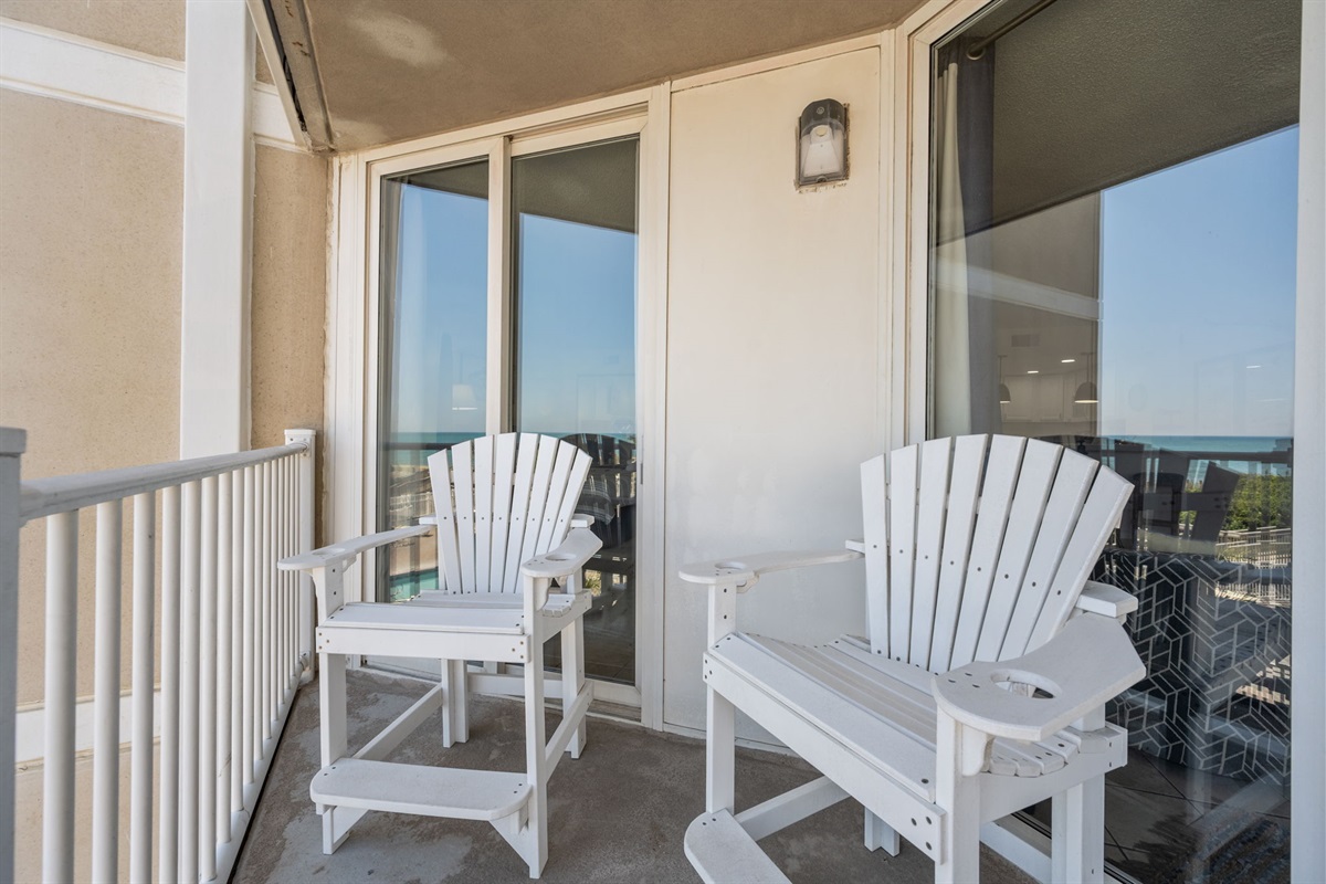 Comfortable Adirondack seating overlooking the pool and beach