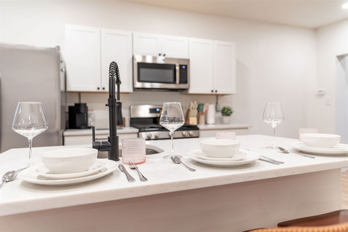Chic kitchen dining countertop featuring a beautiful set of dishes, perfect for enjoying meals in style.