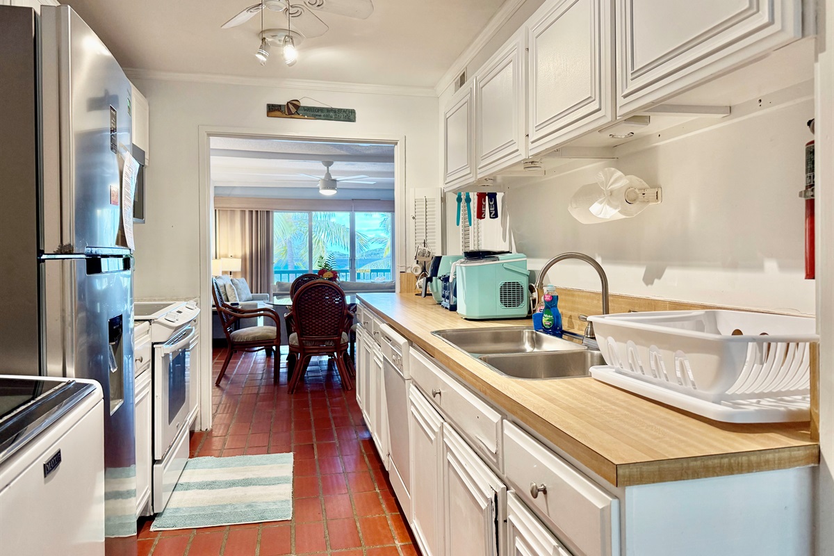 Kitchen with dishwasher, stove and microwave/convection oven combo.