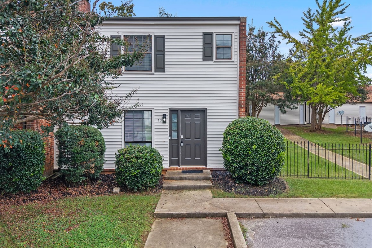 Welcoming front entrance with classic brick accents and well-kept landscaping.
