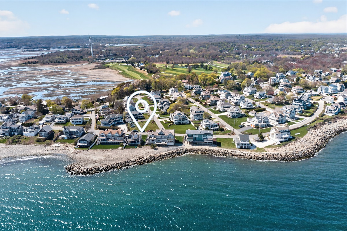 The house framed perfectly against the sparkling coastline.