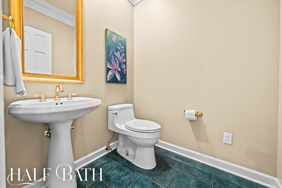 Half Bath: Chic and convenient with golden accents and classic charm.