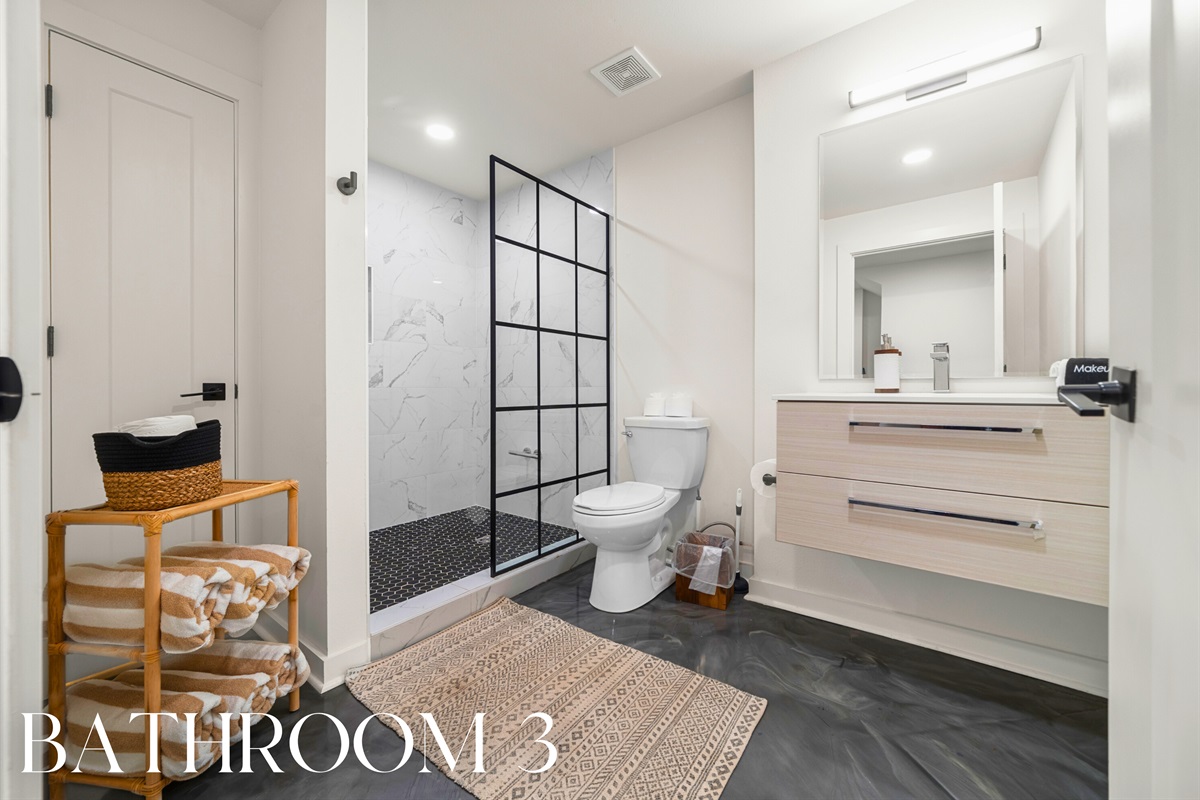 Bathroom with glass shower and fresh modern design.