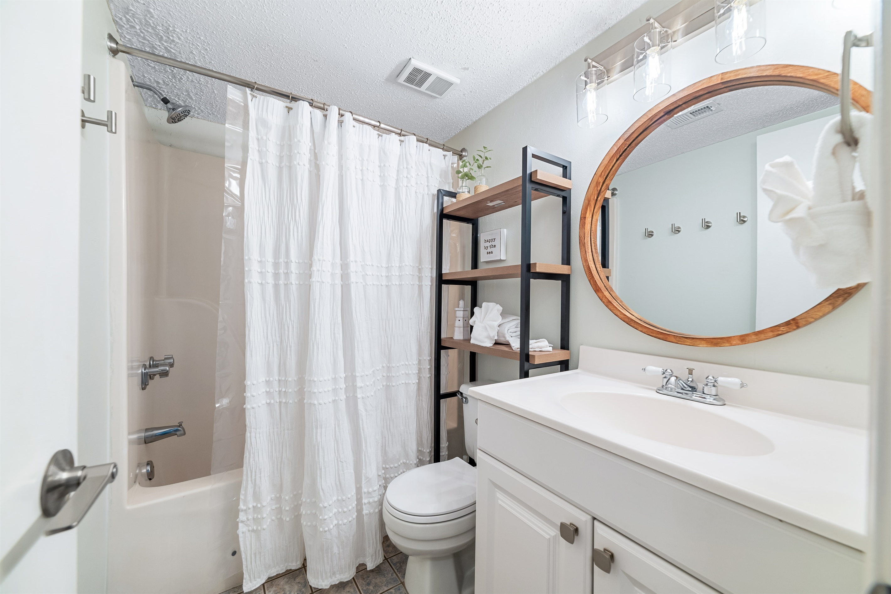 Freshly updated bathroom featuring a shower/tub combination, ample vanity space, and modern fixtures.
