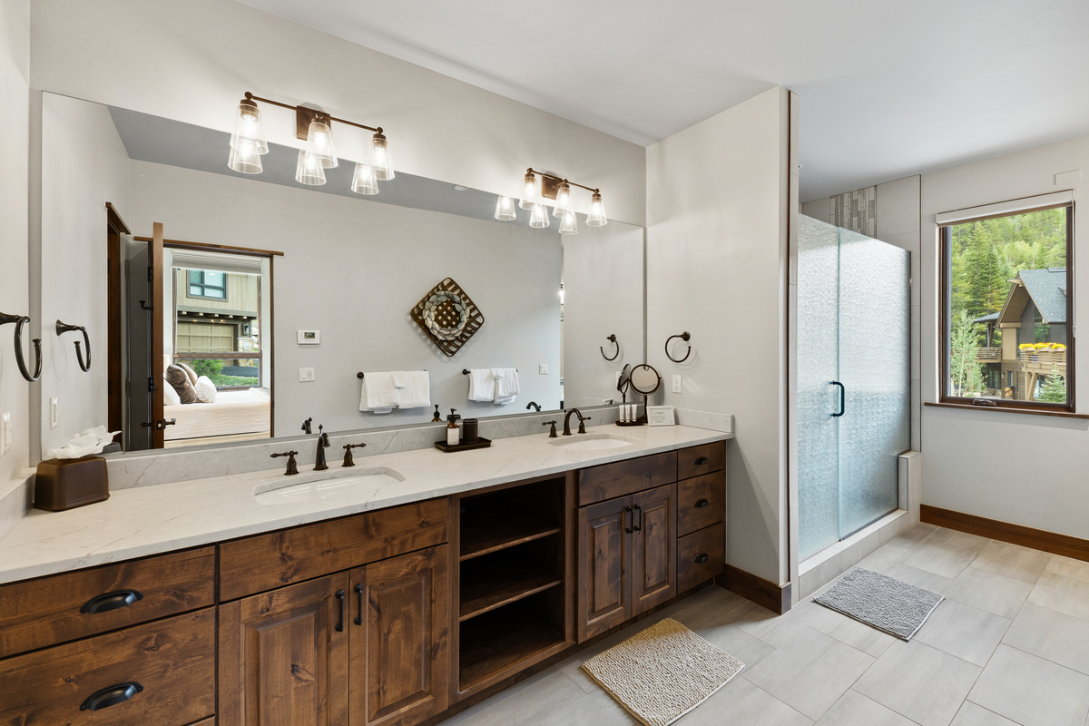 Primary en-suite bathroom with large walk-in shower, dual vanity, water closet and heated floors. 