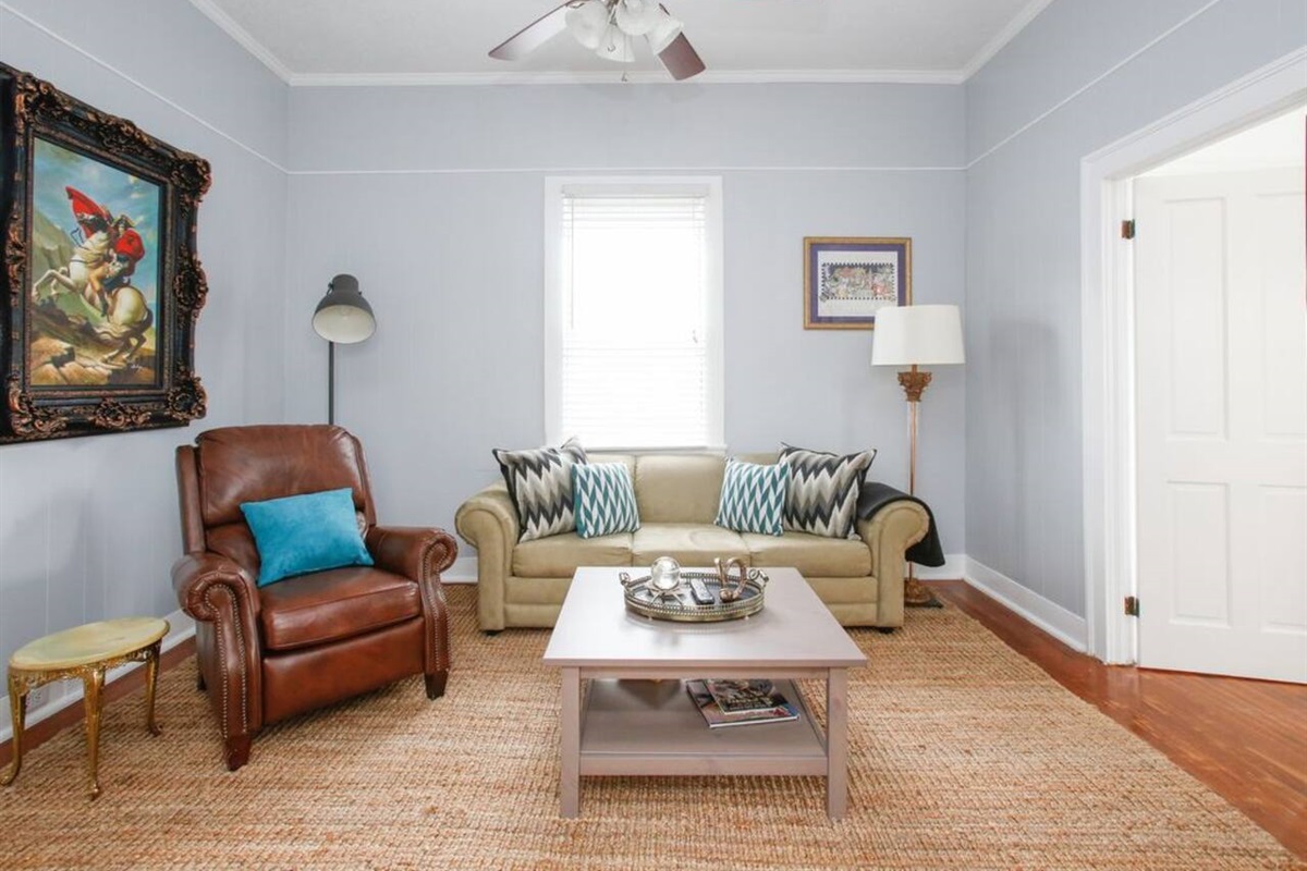 Living room.  Large hdtv and sleeper sofa.  Doors to the right lead to the twin beds bedroom. To the left lead to the kitchen.