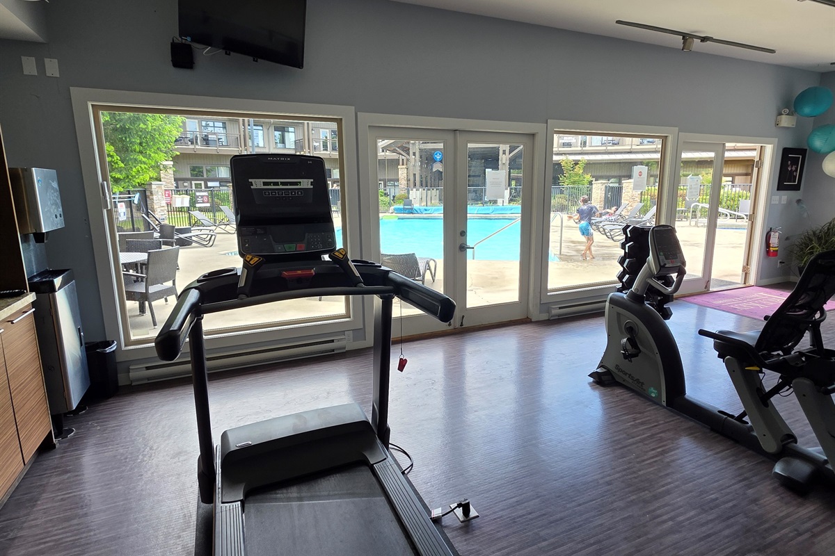 Gym area with a pool view.