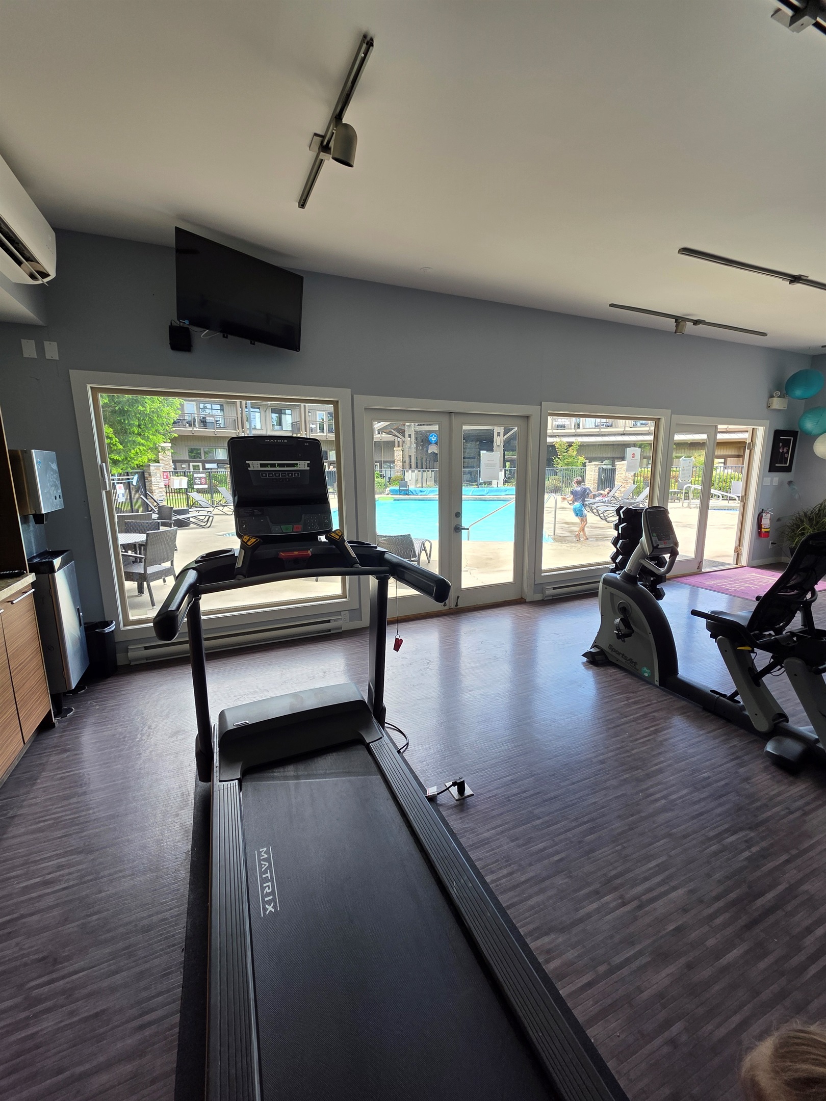 Gym area with a pool view.