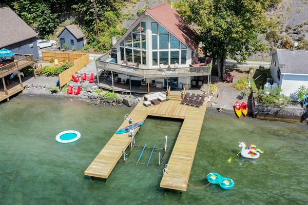 Enjoy breathtaking sunsets as you enjoy a private beach, boat hoist, fishing, kayaks, paddleboards, and more. This stunning retreat offers panoramic views for every floor of the house. Plus a game room, piano and outdoor seating, and lounges. 