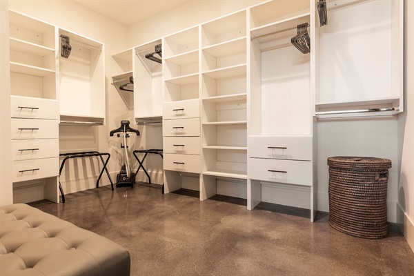 Primary Suite - large walk-in closet with luggage racks, standing steam unit, seating and safe