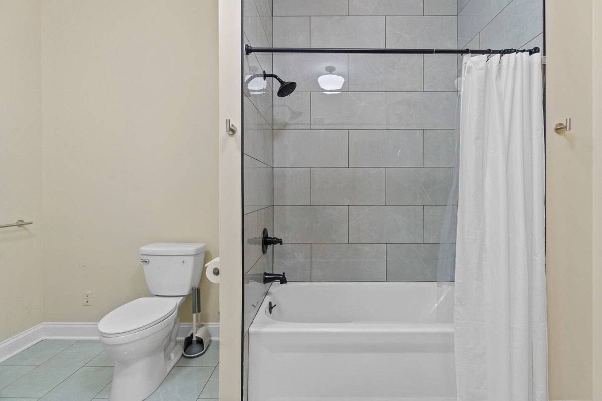 Bathroom featuring a classic combination of a toilet and a tub, providing a comfortable and functional space for relaxation and convenience.