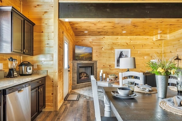 Indulge your inner chef in this kitchen, featuring state-of-the-art appliances, an expansive dining table, and a gallery of tasteful artwork.