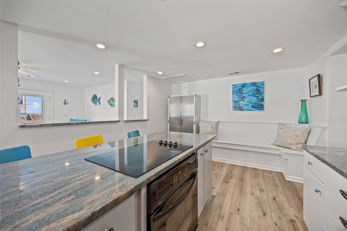 Island seating with ample prep space and an easy view into the living area