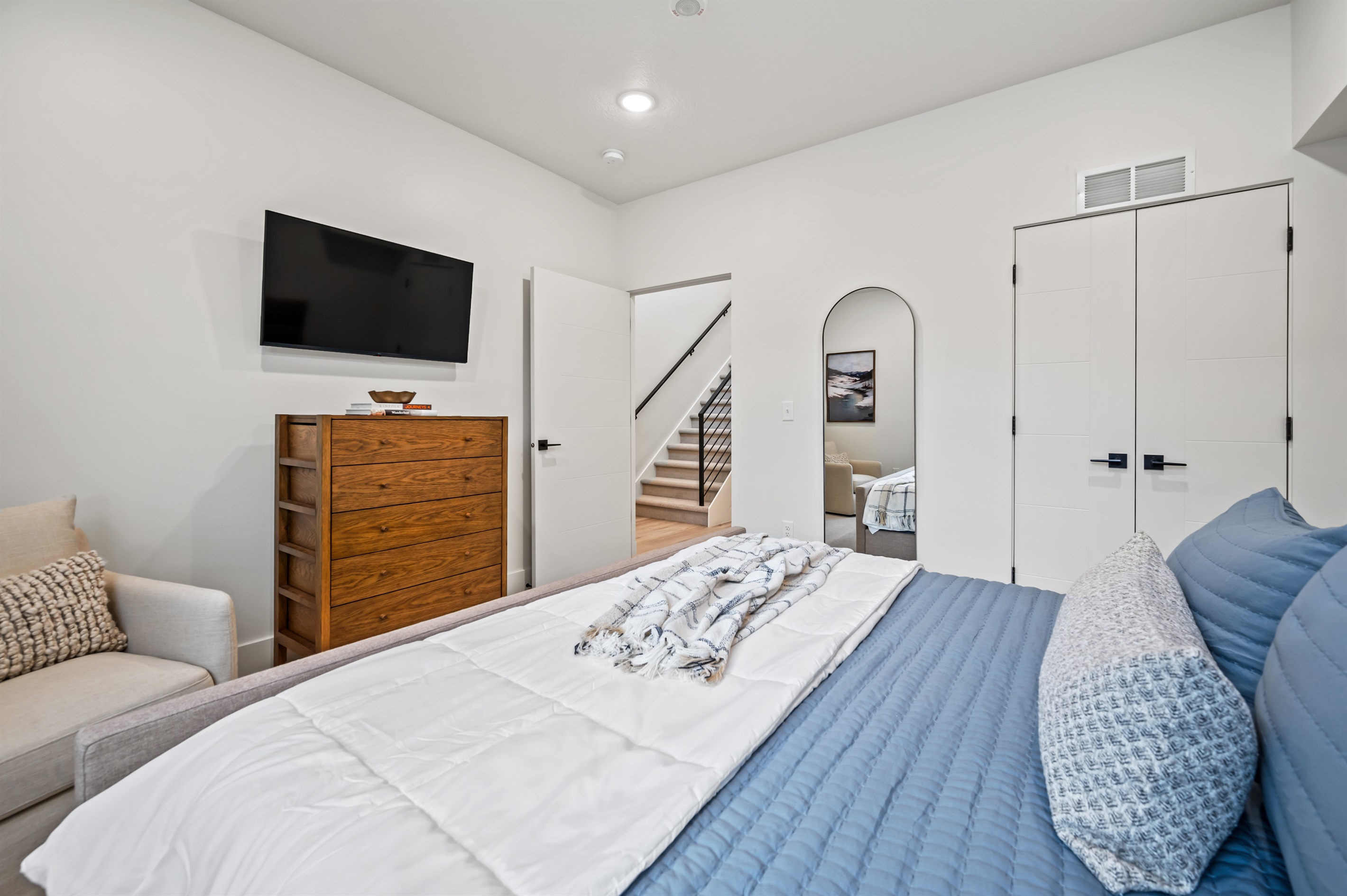 This bright bedroom offers a king bed, roomy closet, and dresser — making it easy to unpack and feel at home.