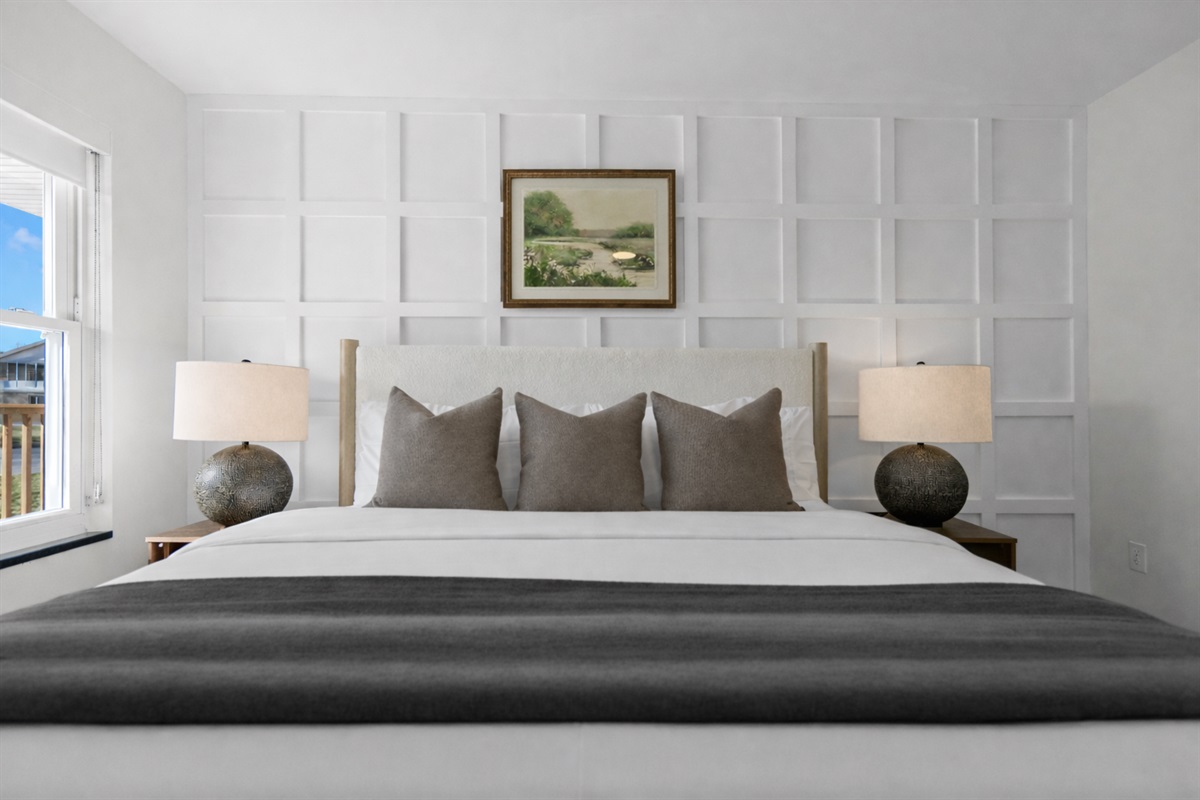 Serene bedroom featuring a plush bed, elegant accent wall, and warm lighting—creating a calm, comfortable retreat for restful nights.