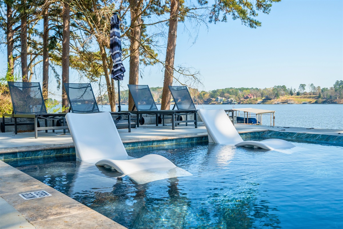 Take in the modern pool design as it extends toward the lake, blending clean lines with natural surroundings for a truly relaxing backdrop.