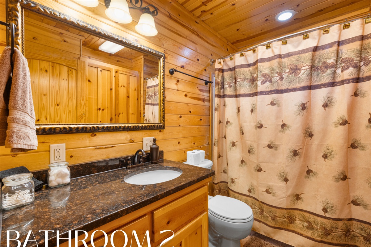 Bathroom 2 with rustic cabin touches and full shower/tub combo.