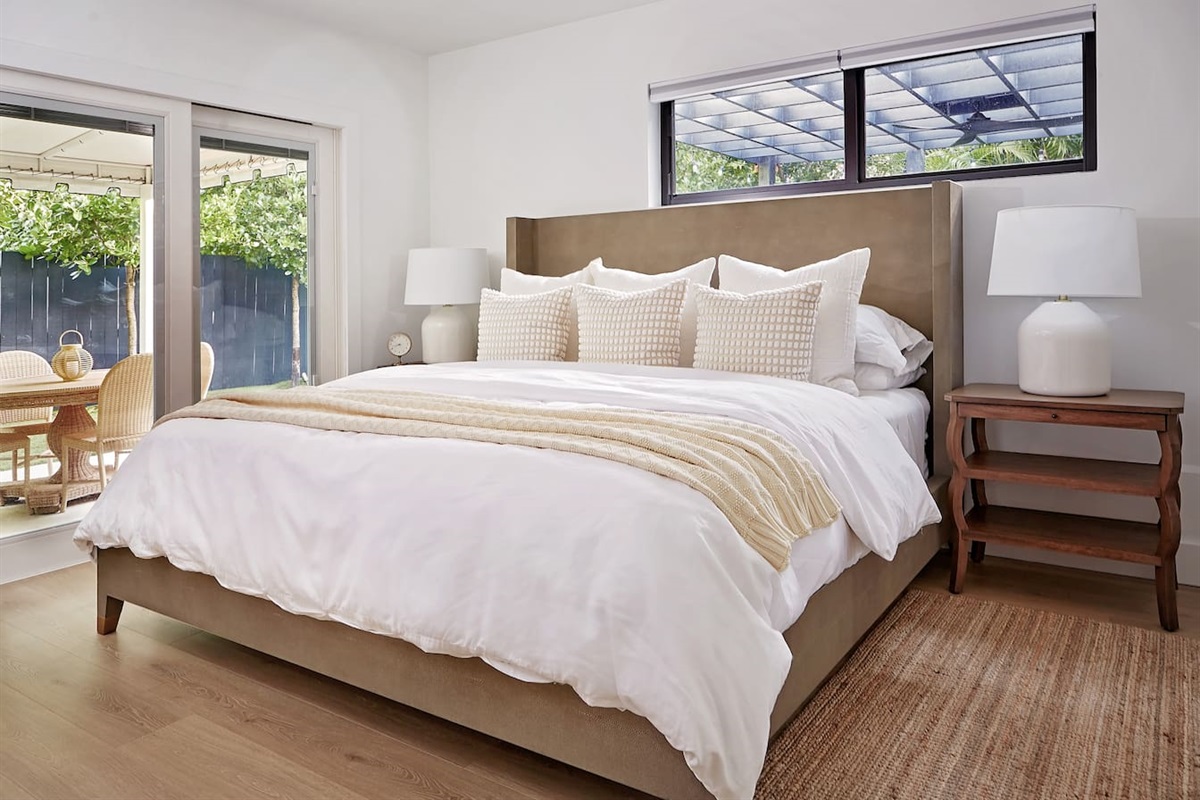 The first-floor king suite overlooks an outdoor patio with a rattan table—perfect for enjoying morning coffee. Inside, you’ll find an award-winning WinkBed mattress with 800-thread-count linens, and a plush down comforter for a restful night’s sleep.